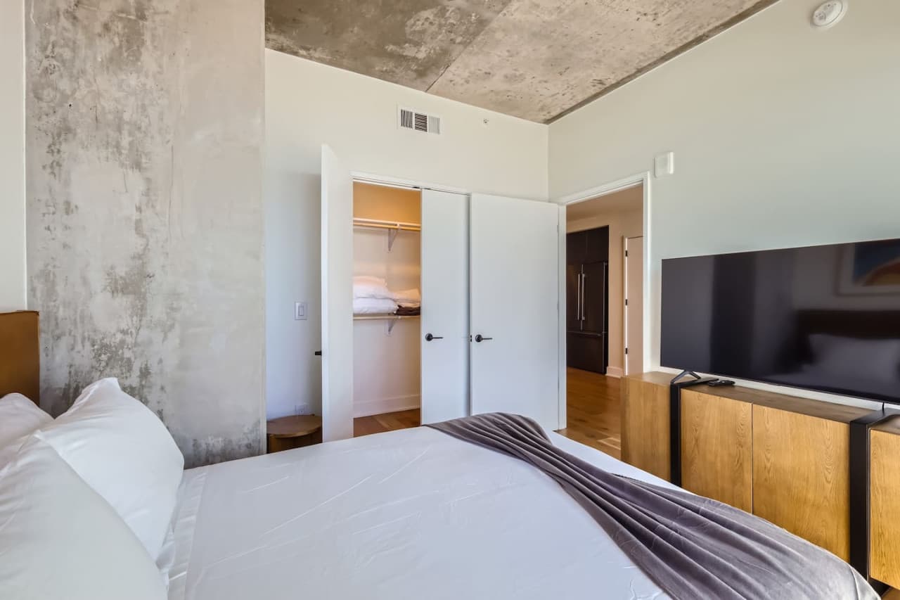The bedroom features a Smart TV for streaming and a queen size bed.