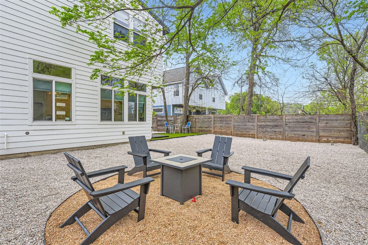 Gather around the cozy fire pit in the backyard, perfect for creating lasting memories under the starlit Texas sky.