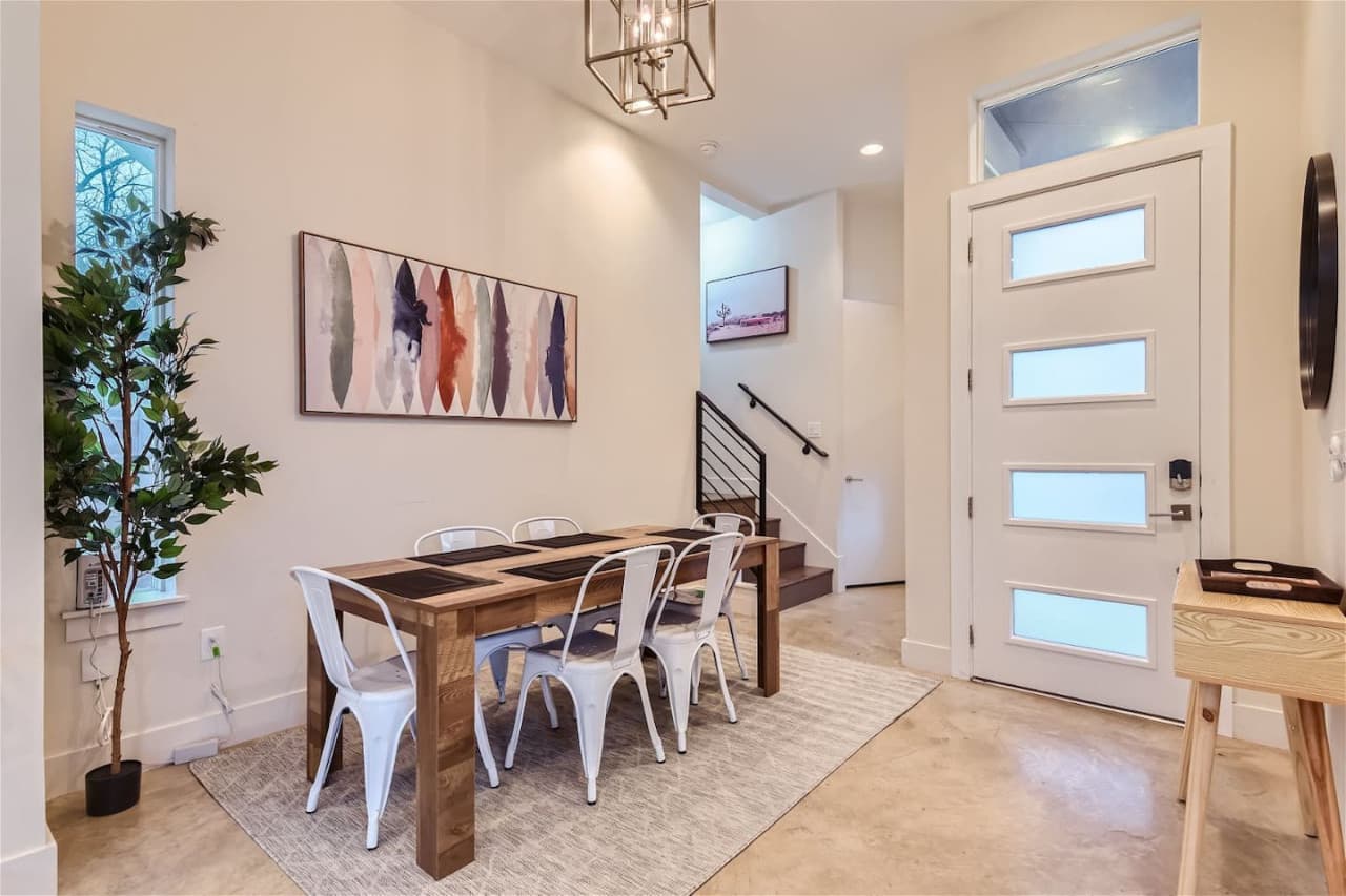 Indulge in a delicious, home-cooked meal surrounded by elegant decor and natural light streaming through floor-to-ceiling windows. Dining room seating for up to six.