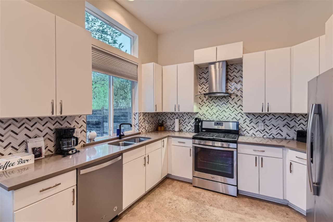 The kitchen is fully equipped with all the essentials for cooking and dining, including stainless steel appliances, a coffee maker, and a blender for those refreshing summer drinks.