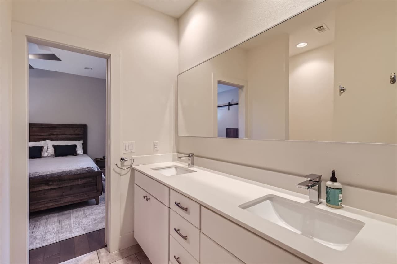 The principal bedroom benefits from an exclusive attached bathroom featuring double vanity sinks.