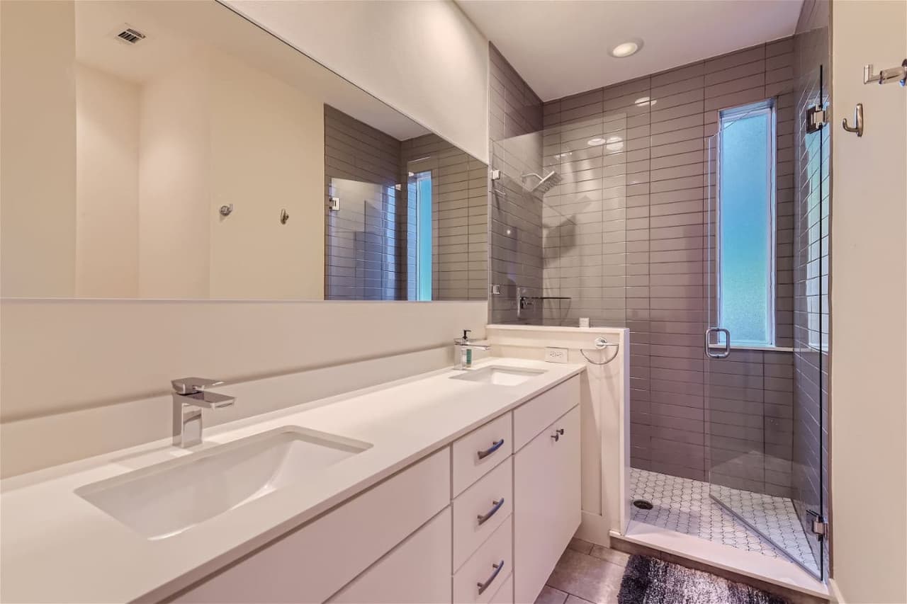 Step in shower and double vanity sinks featured in the master en-suite bathroom.