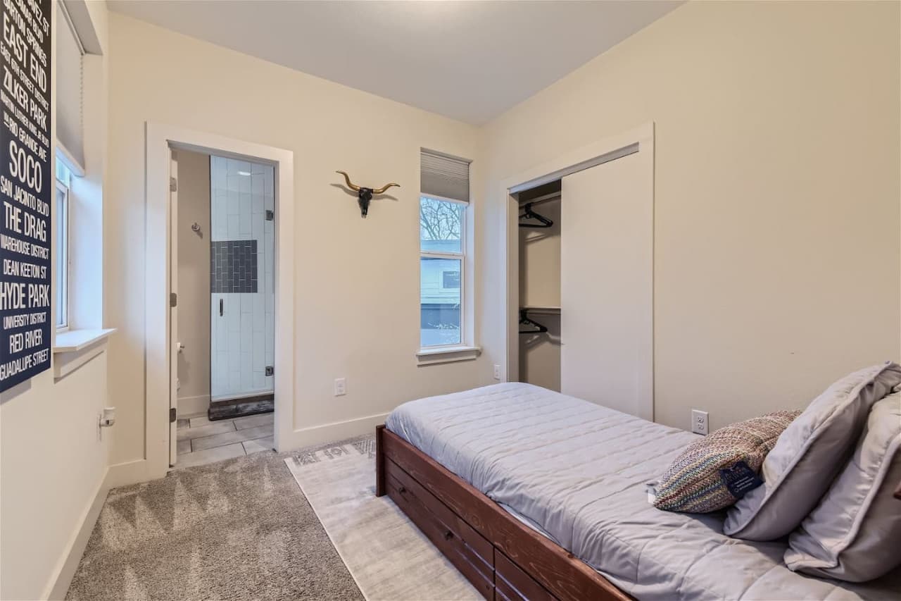 Second bedroom features two single beds.  One is a pull-out trundle. Direct access to the full bathroom with a step-in shower.