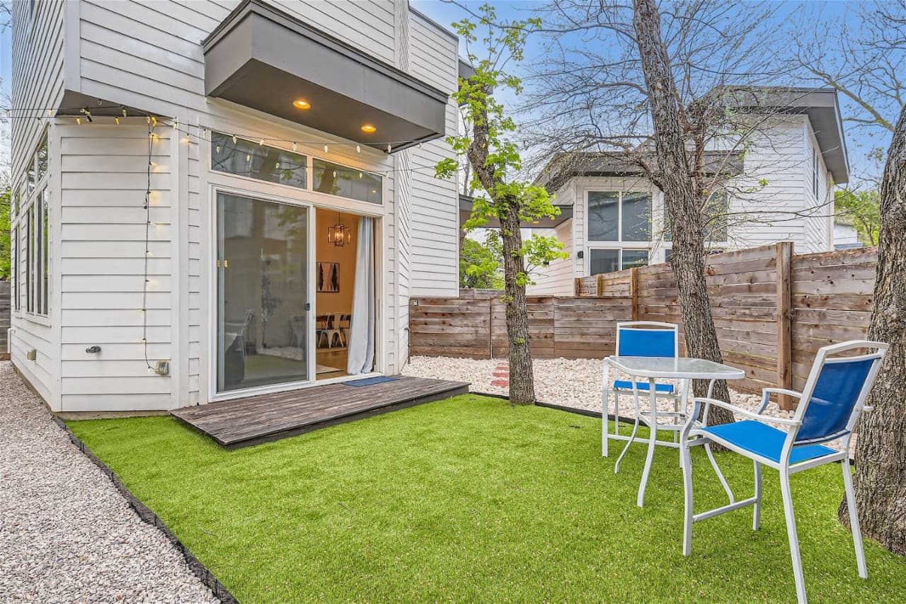 The private backyard is equipped with outdoor furniture and twinkle lights, making it the perfect spot for al fresco dining or just enjoying your morning coffee.