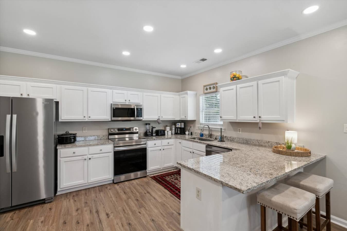 The fully equipped kitchen is a culinary haven, complete with modern appliances, ample counter space, and all the essentials for preparing delicious, including drip coffee maker and a fully stocked coffee bar for your stay.