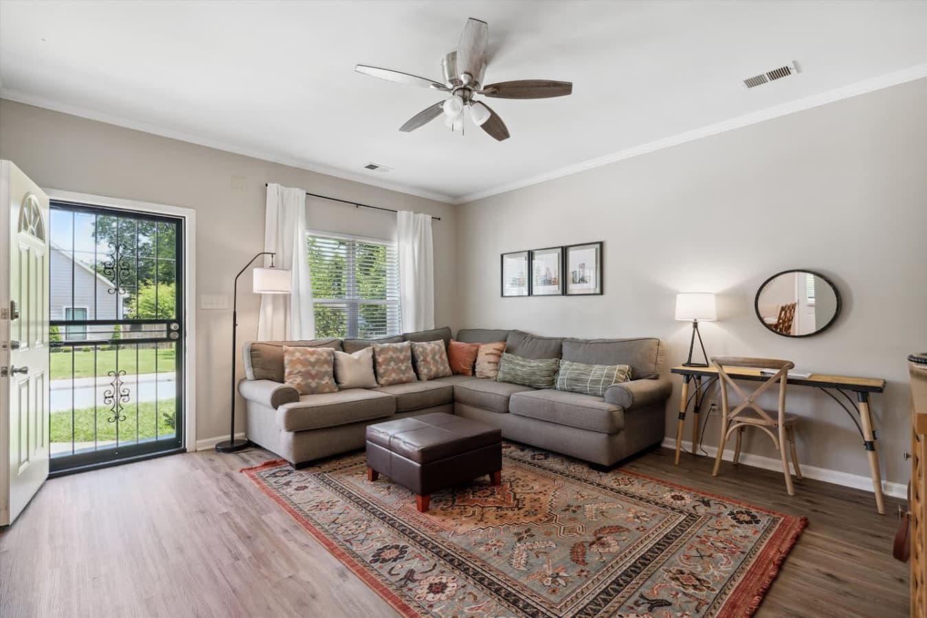 Living room space featuring a sectional, work station and Smart TV for streaming.