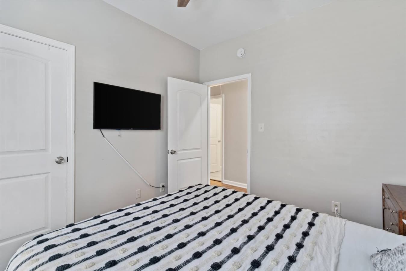 The second bedroom offers a relaxing retreat with a queen-size bed for a good night's sleep and a Smart TV for enjoying your favorite entertainment.