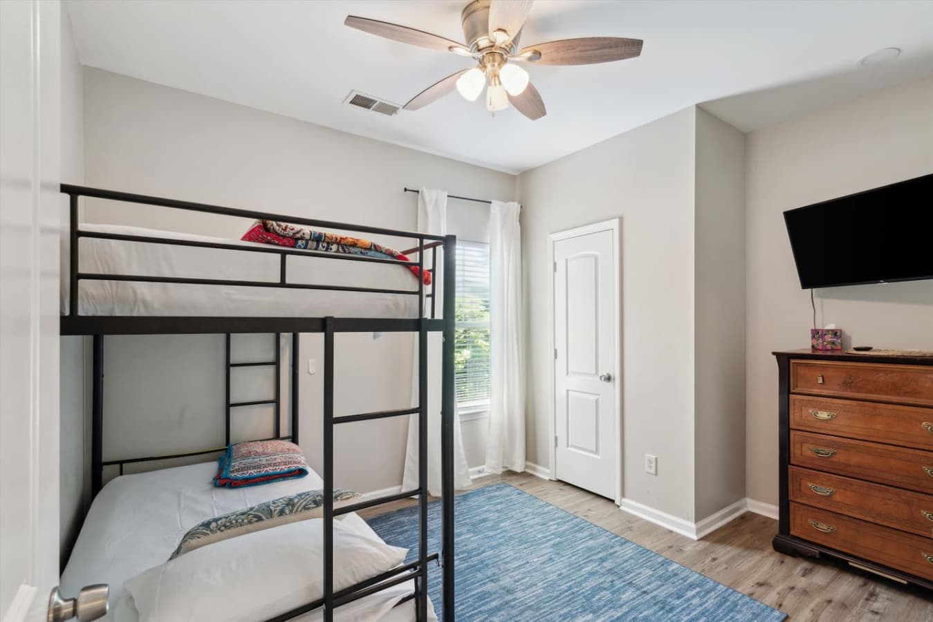 Designed with little ones in mind, it features a delightful bunk bed set and a convenient pull-out trundle, ensuring comfortable and restful nights for up to three children.