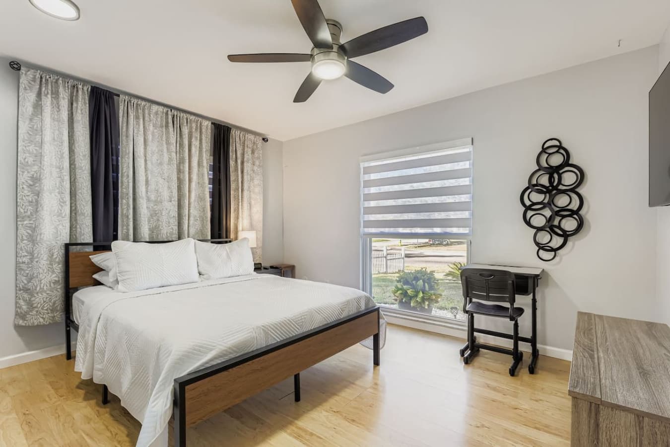 Third bedroom offers a comfortable queen bed, smart TV and dedicated workspace.