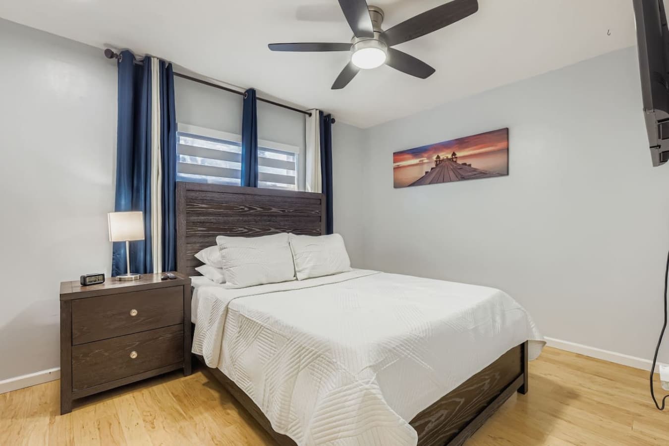 The fourth bedroom features a queen size bed and smart TV for comfort.