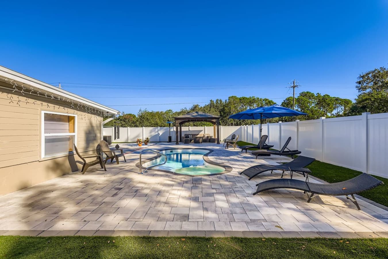 Loungers, grass, and good vibes, this sun-soaked yard gives you options to relax however you like.