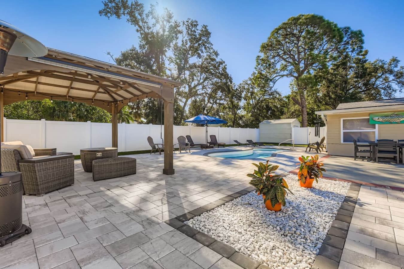 A photo-worthy backyard escape, beautifully landscaped and designed for comfort, this pool area is made for memories.