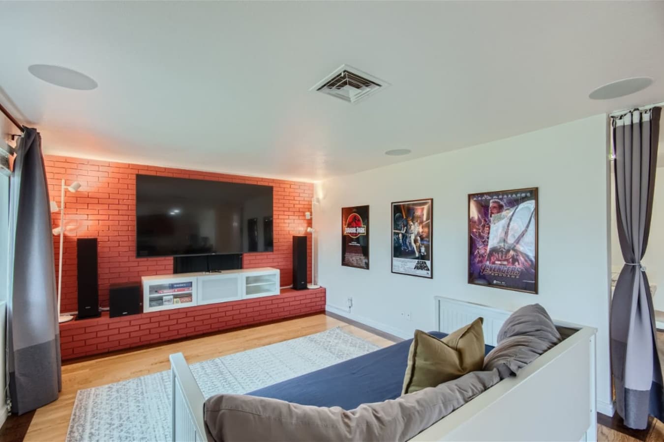 Media room featuring a home theater system and a Smart TV for streaming your favorite shows, with a daybed for an additional comfortable sleeping option.