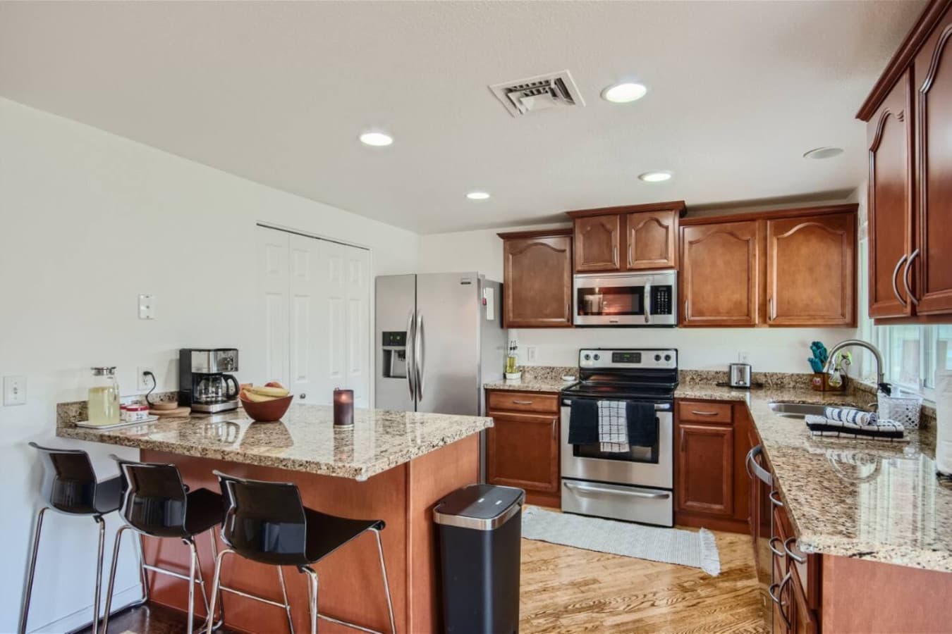 The kitchen is fully equipped with all the essentials for cooking and dining, including stainless steel appliances and a coffee maker.