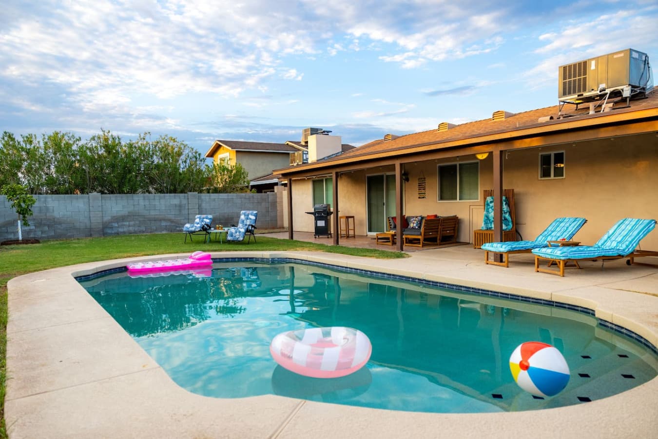 The backyard provides a private sun soaked oasis featuring a private pool and gas propane BBQ.
