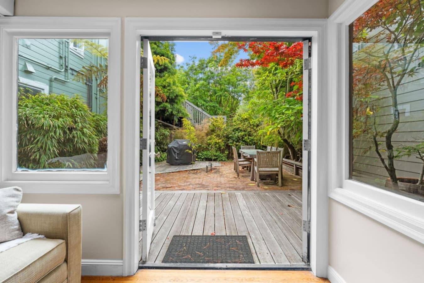 Explore the backyard featuring a outdoor area to eat and a BBQ.
