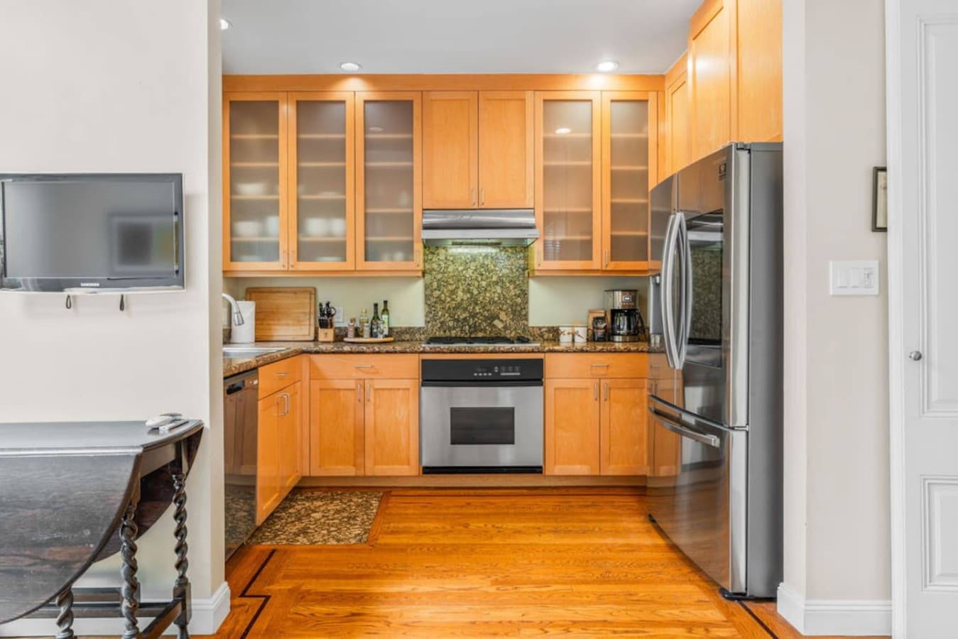 Full kitchen with stainless steel appliances.