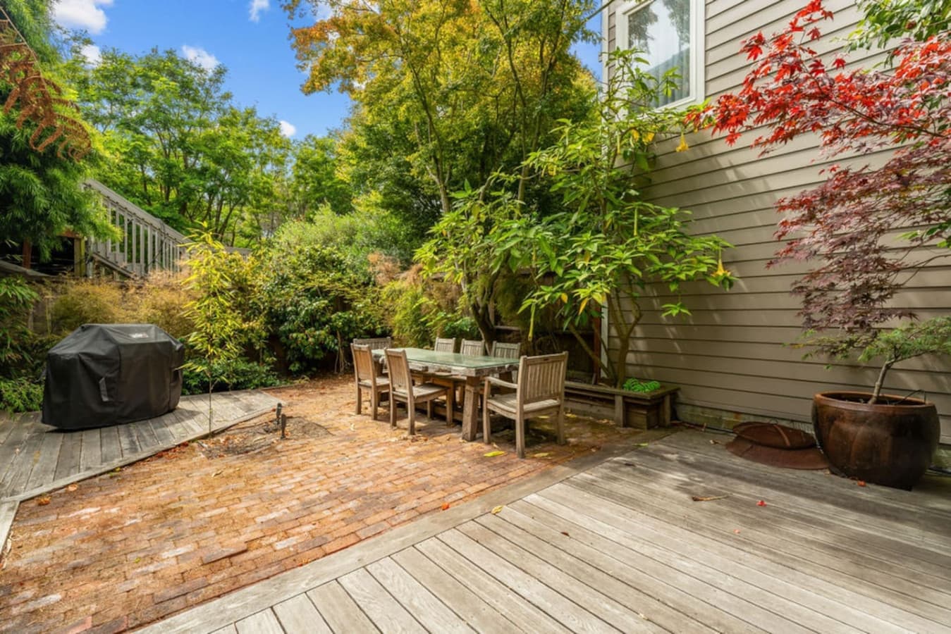Backyard with outdoor seating and BBQ.