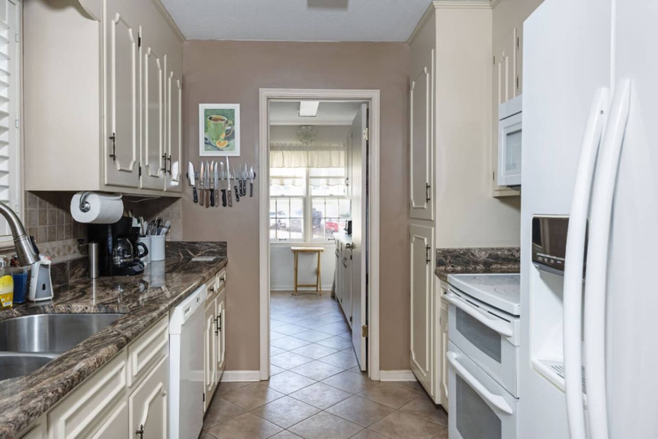 A bright kitchen with ample counter space and easy access to the dining area.
