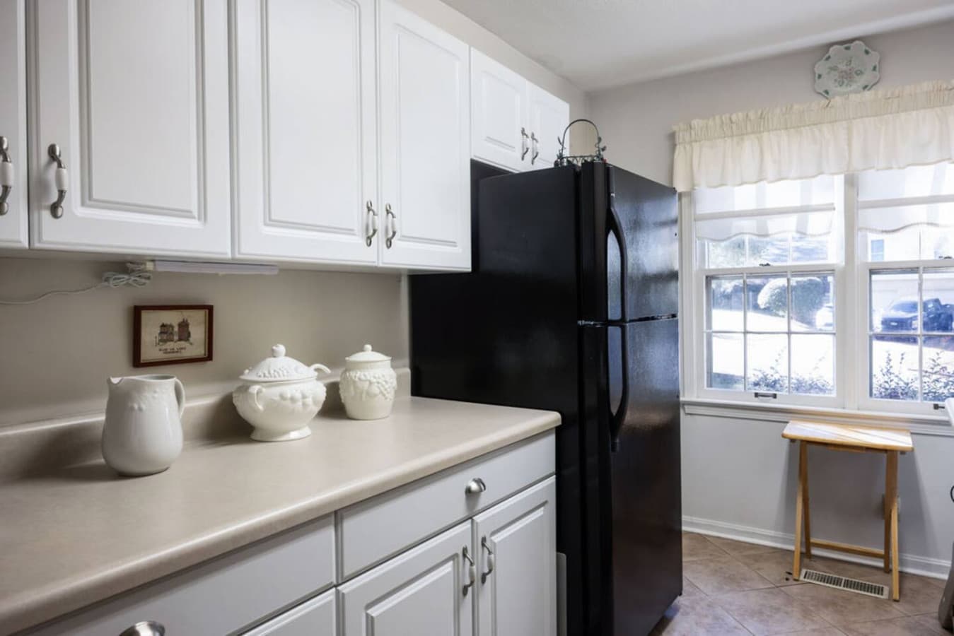 Clean countertops and classic cabinetry creating a functional cooking space.