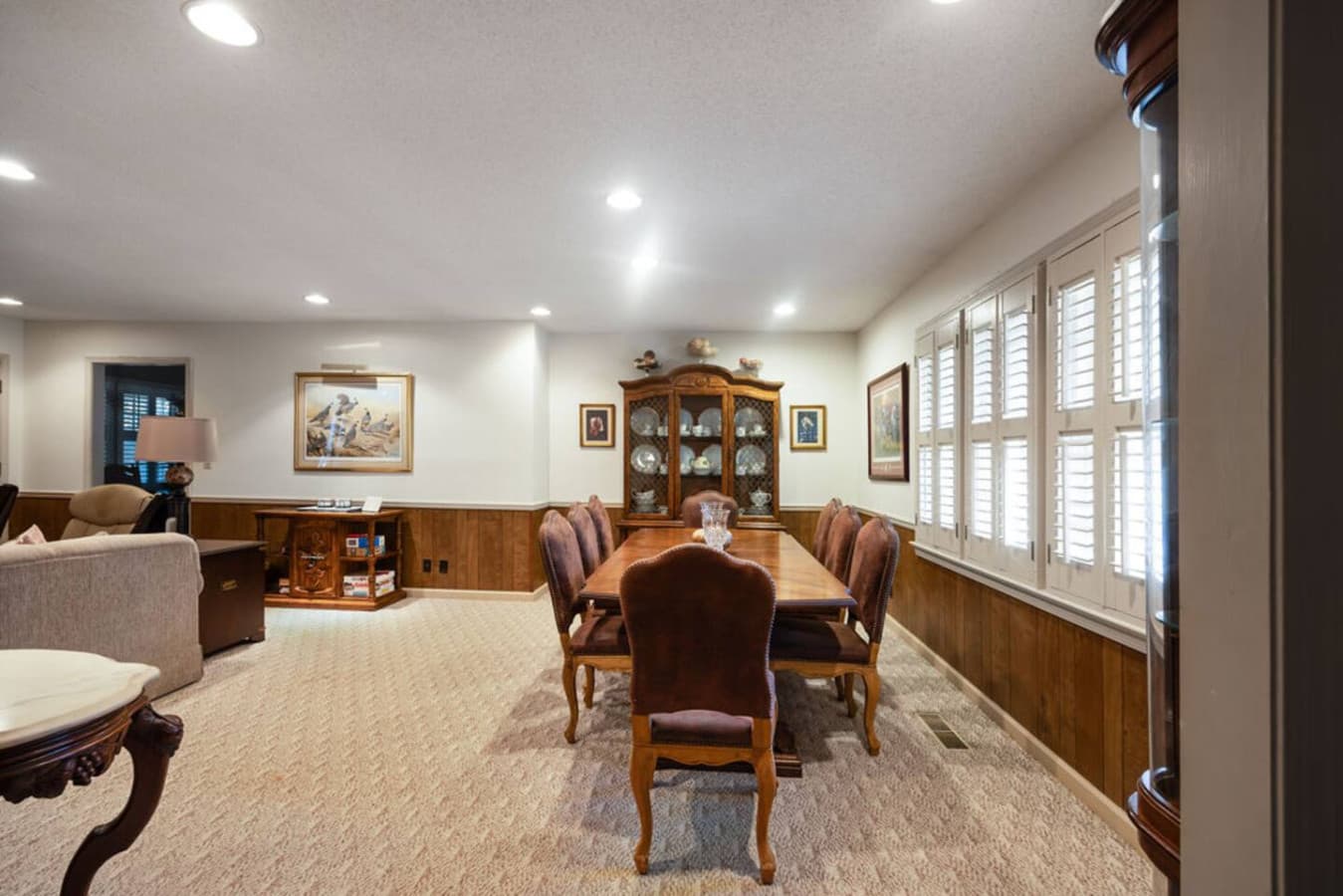 A welcoming dining room featuring classic furnishings and bright window views.
