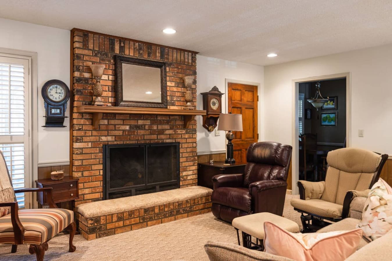 A cozy living area with a classic brick fireplace creating a warm focal point.