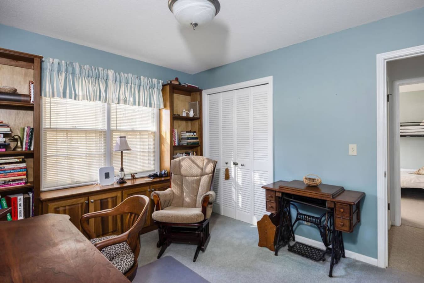 A cozy study room with classic furniture and bright natural light.