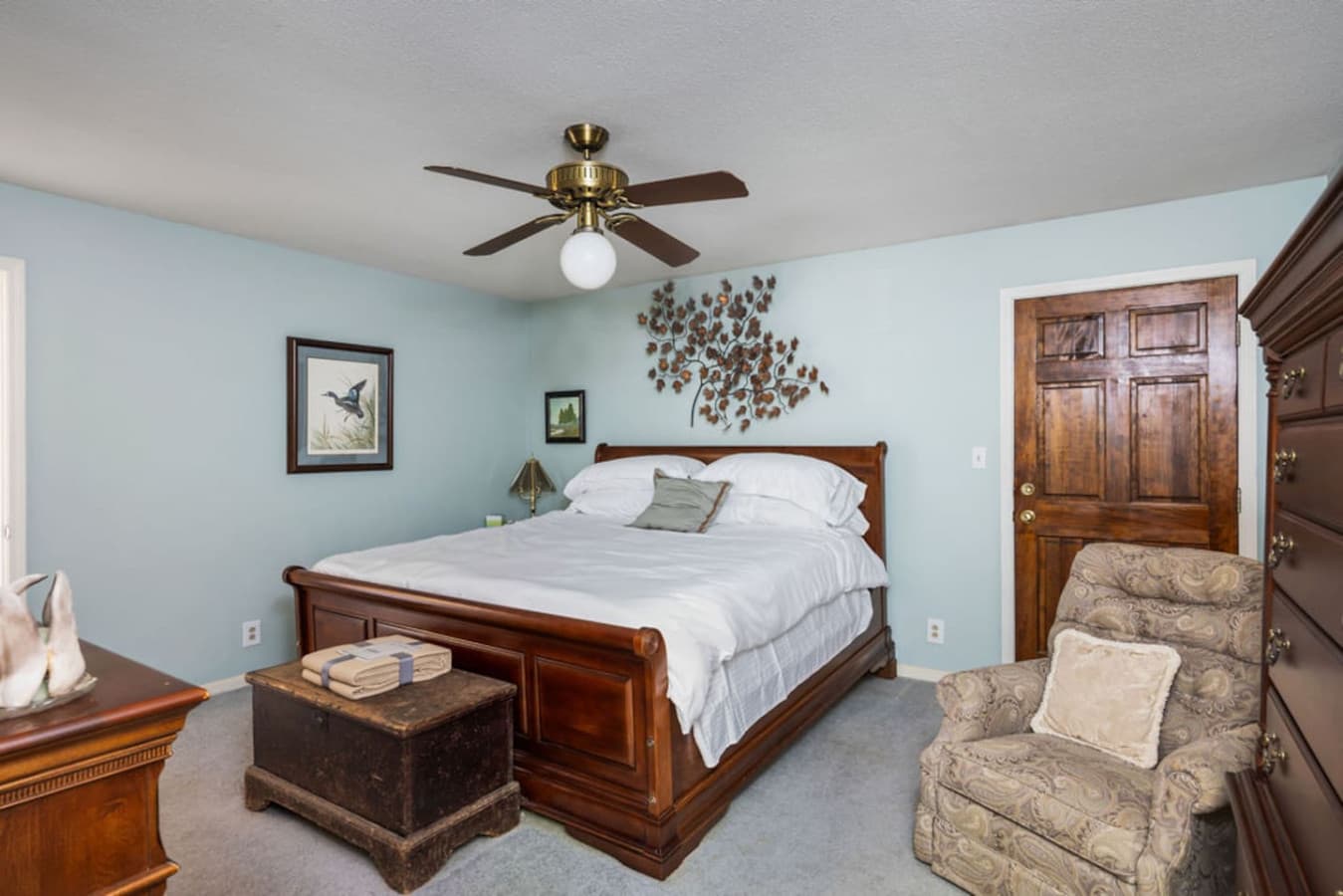 A bright bedroom with a comfortable bed and calming decor.