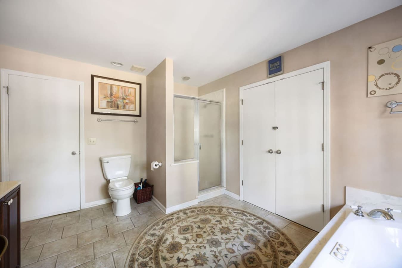 A clean bathroom with a walk-in shower and spacious layout.