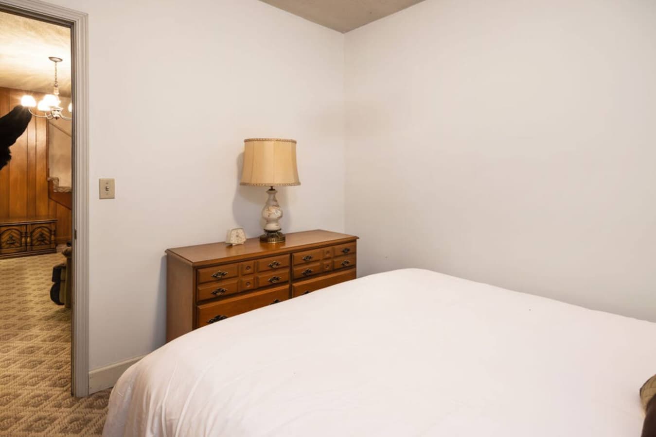 A bright bedroom with classic furnishings and soft lighting.