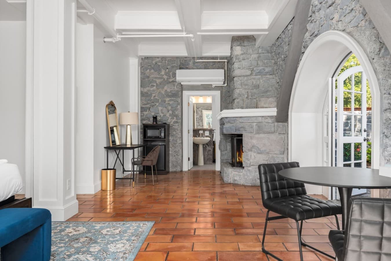 This is the private suite you will be renting showcasing historic stone details, a fireplace, and a dedicated seating area.