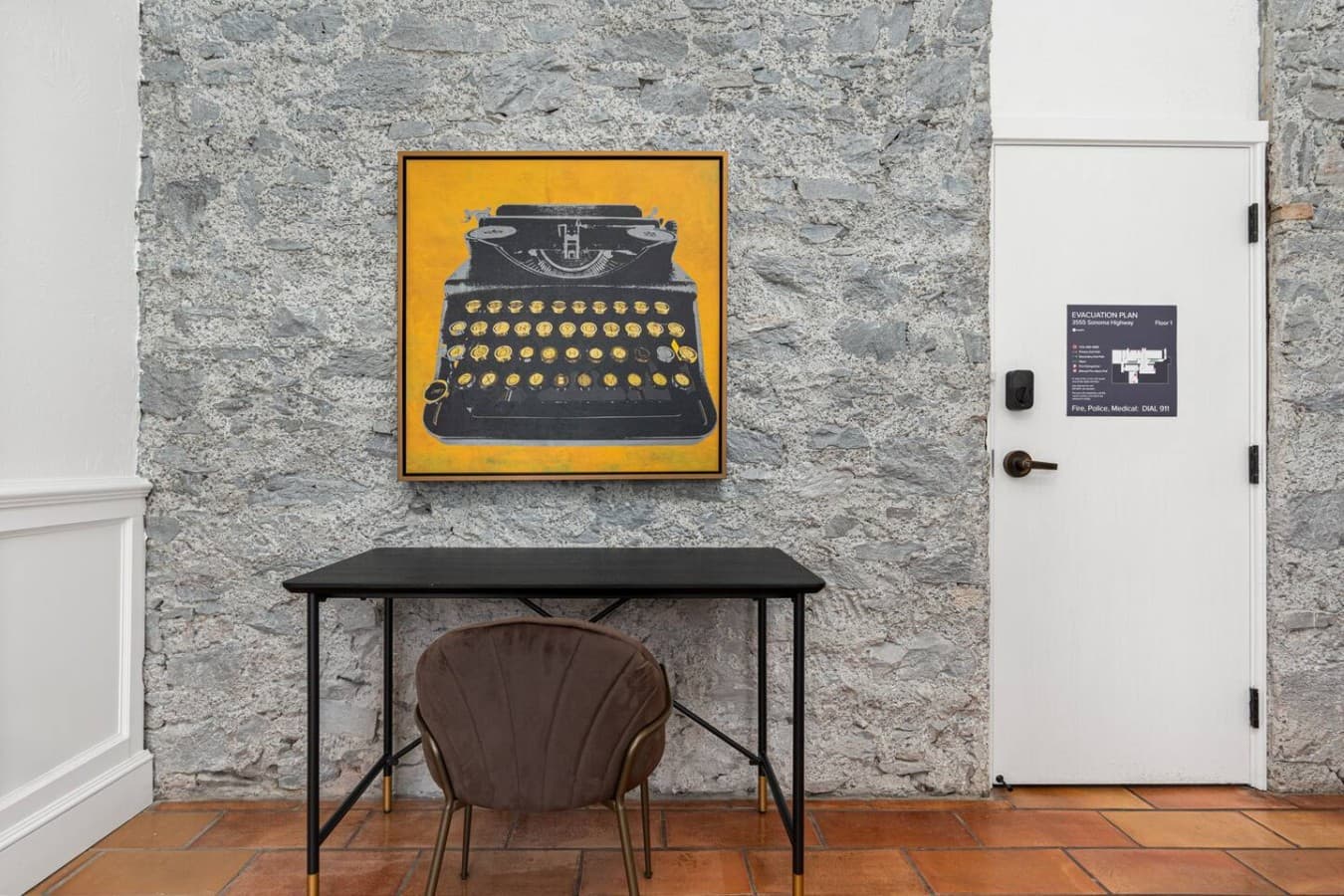 A private workspace in the room with a stylish desk setup for reading, writing, or remote work.