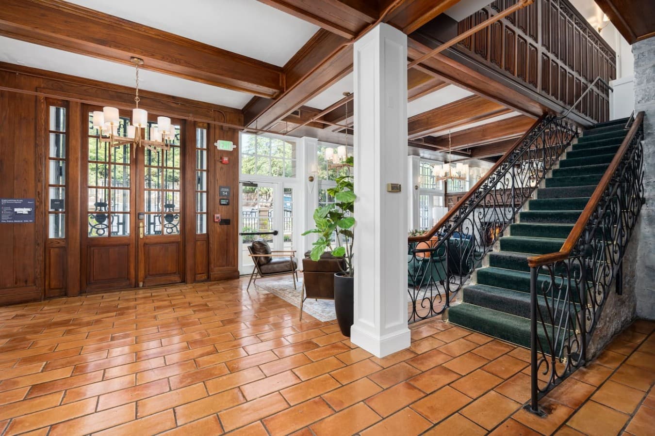 A bright shared entry area with warm tile floors and classic architectural details located in the hotel’s common space and not inside your private room.