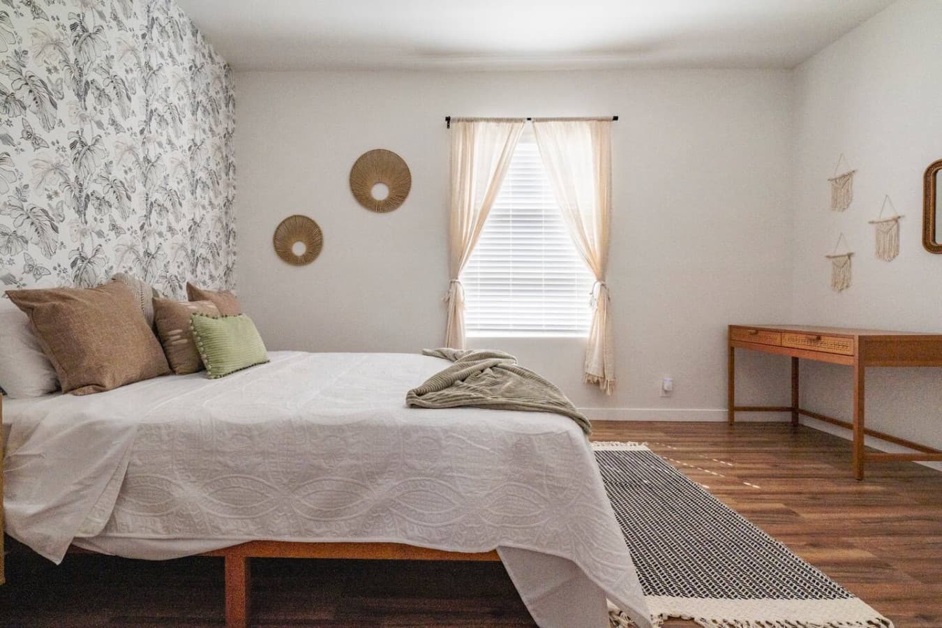 Cozy master bedroom with an individual split ac unit and queen size bed.