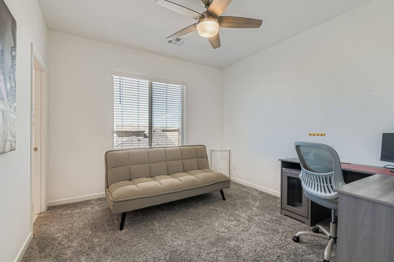 Dedicated workspace and futon bed in the third bedroom.