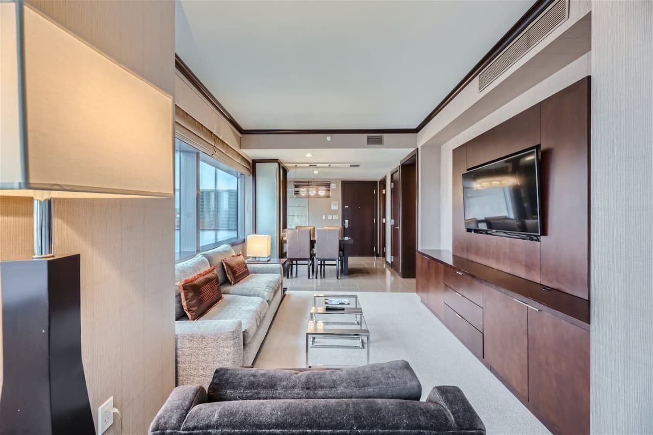 Separate living room with queen-size pull-out sofa bed, arm chair, workstation, coffee table, and 42" digital LCD flat-screen TV.