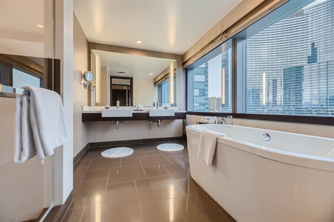 Spa style master bathroom with double-sinks, deep soaking tub, & glass-enclosed walk-in shower with built-in seat. Additionally, a private half-bathroom off the living room/kitchen.