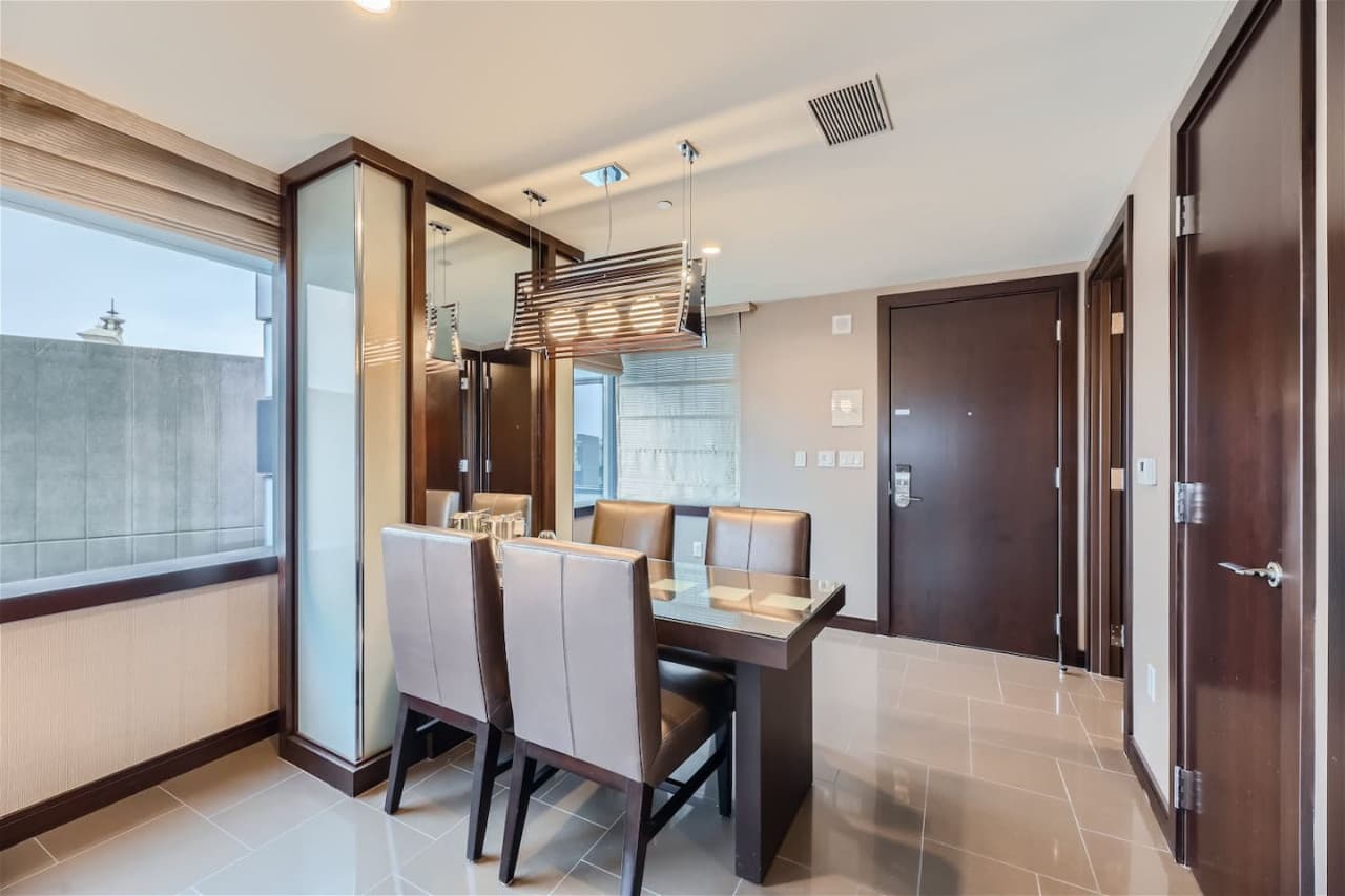 Dedicated dining area with wood and glass dining table for two.