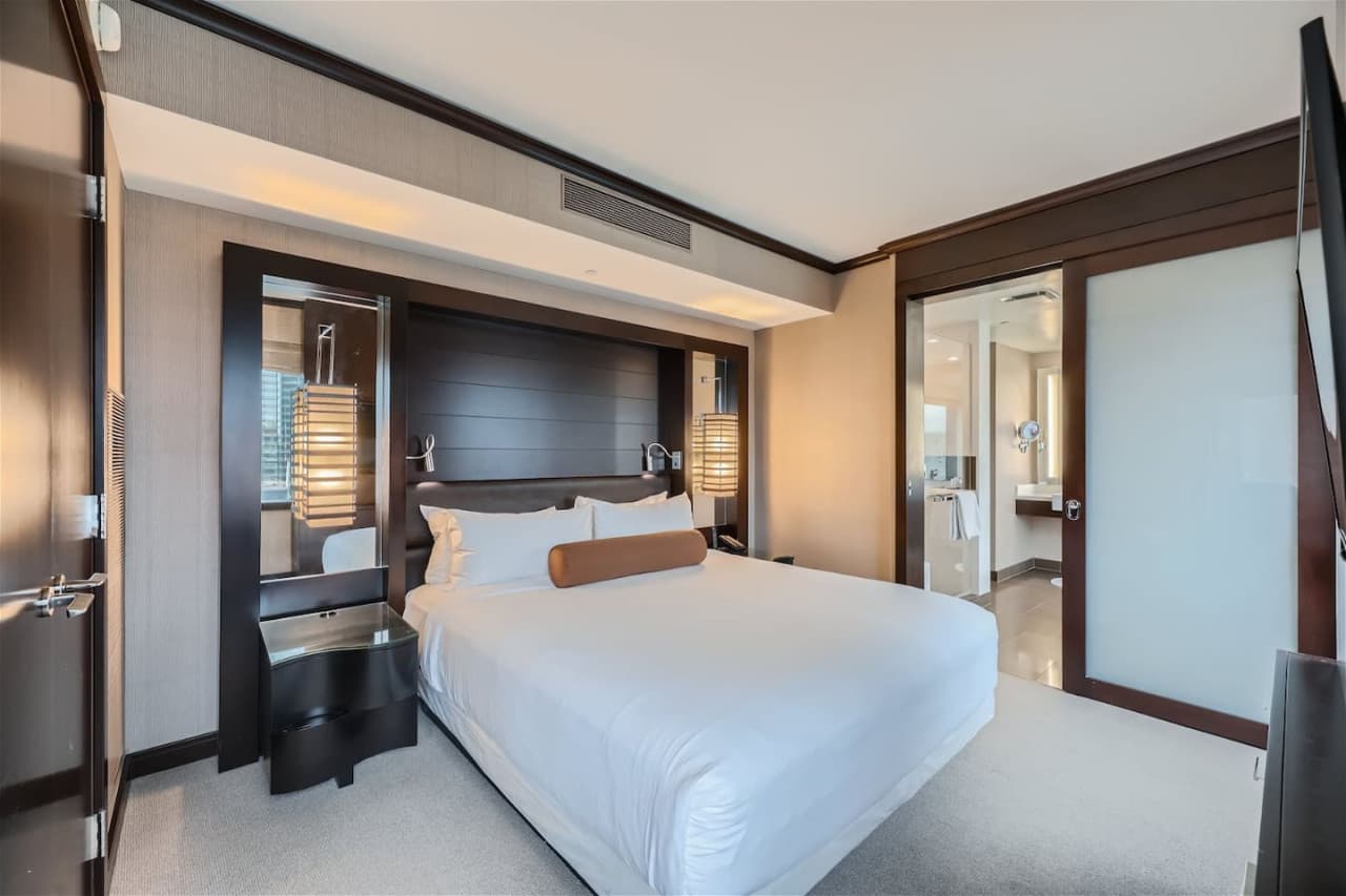 This luxurious one-bedroom corner suite located on the 9th floor of Vdara features a king bed with an ensuite master bathroom with a soaking tub.