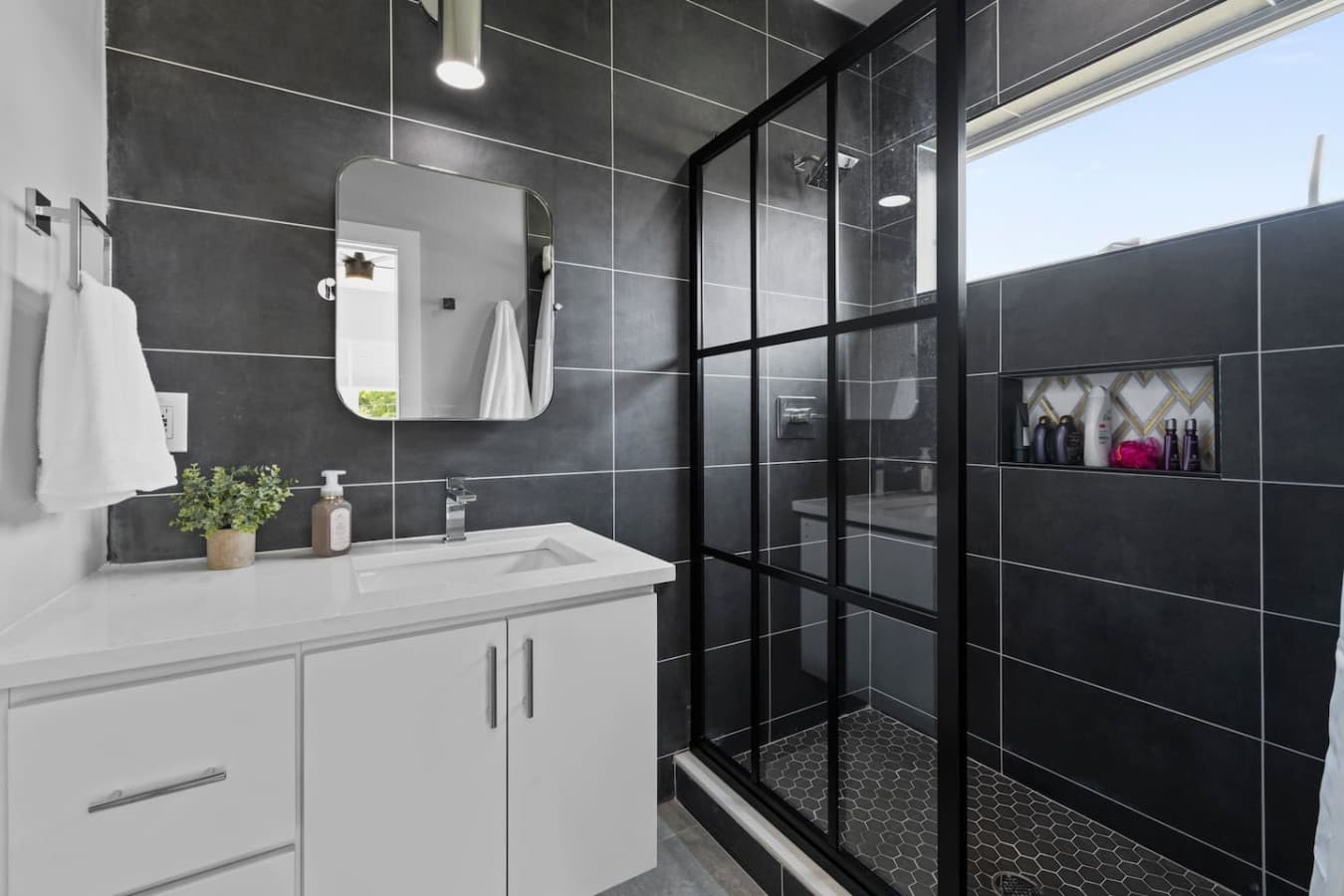 Full bathroom with spacious walk-in shower.