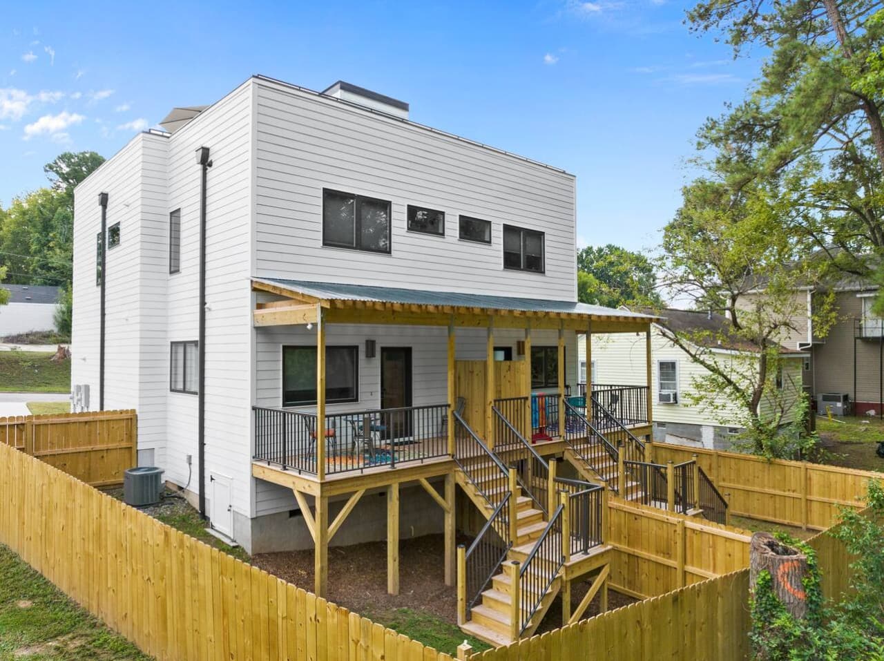 Private covered back porch with its own stairway, cozy seating, and colorful accents.