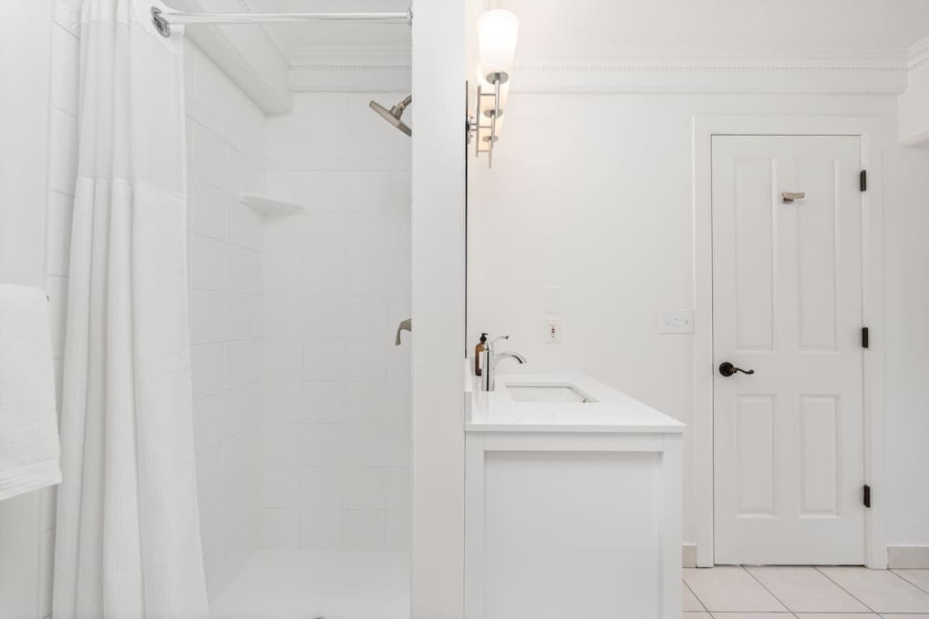 This is the private bathroom inside the room you will be renting featuring a clean walk-in shower and bright, modern finishes.
