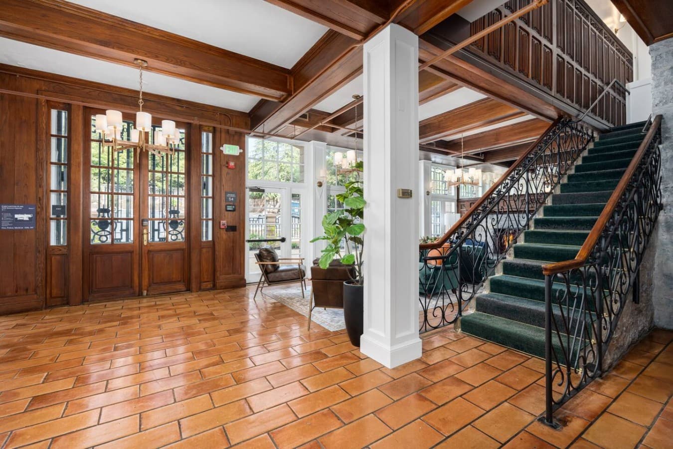 A bright shared entry area with warm tile floors and classic architectural details located in the hotel’s common space and not inside your private room.