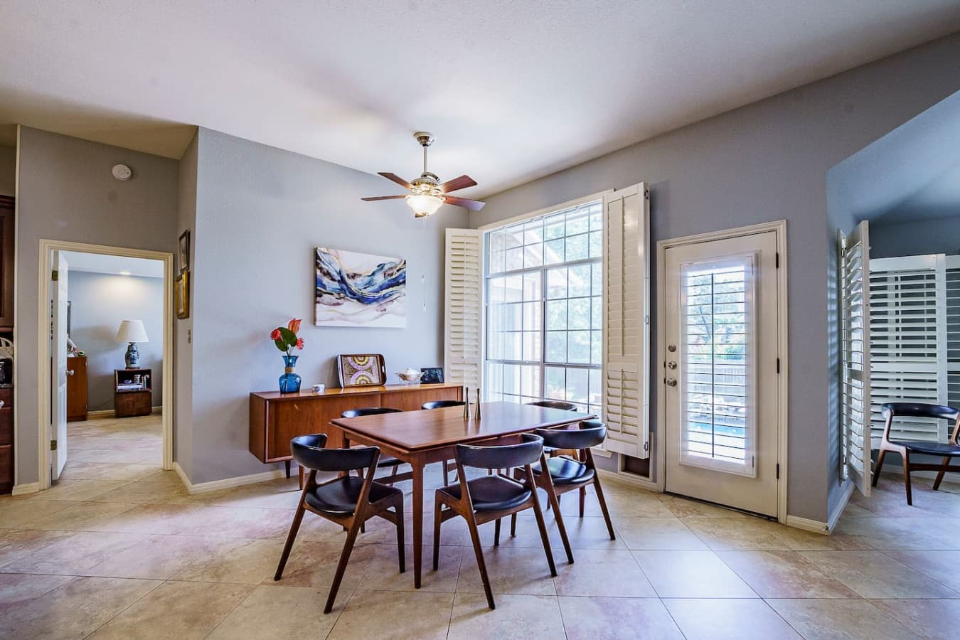 Dine in comfort with sunlight streaming through large patio doors.