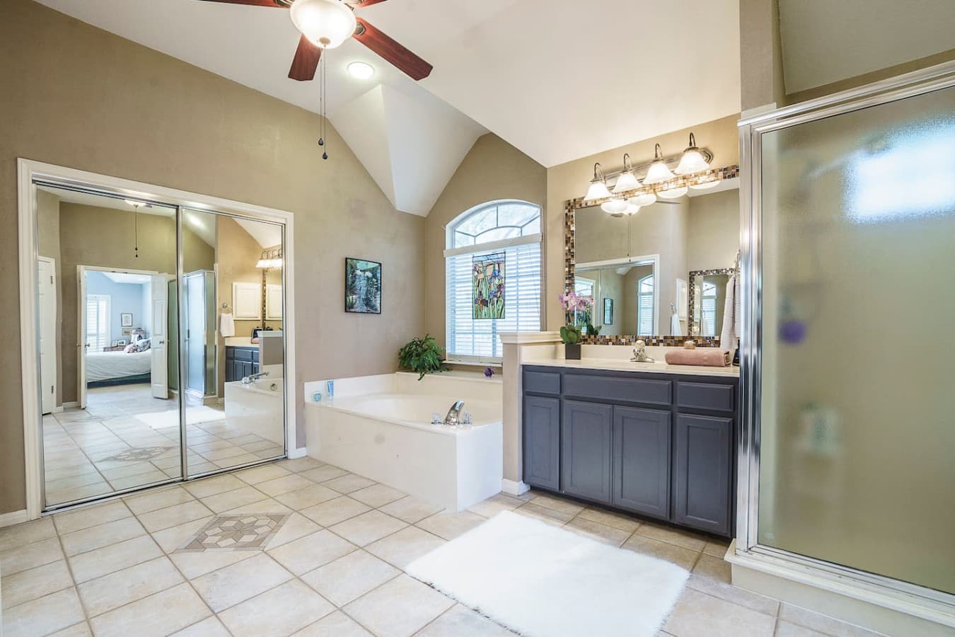 Master bathroom with a jetted bathtub.