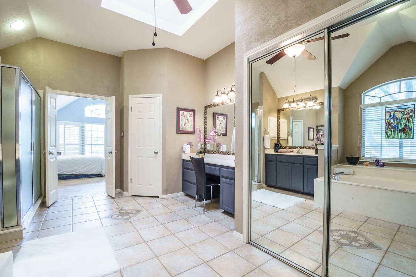 Master bathroom with double vanities, walk in shower and jetted bath tub.