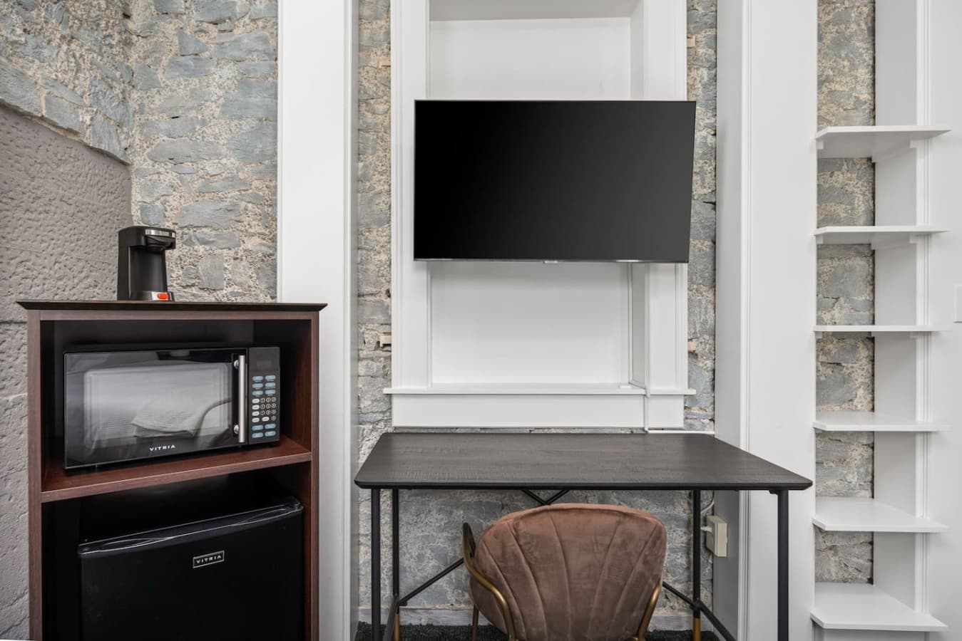 This is the private room you will be renting featuring a dedicated workspace, a mounted TV, and an in-room microwave and mini fridge.