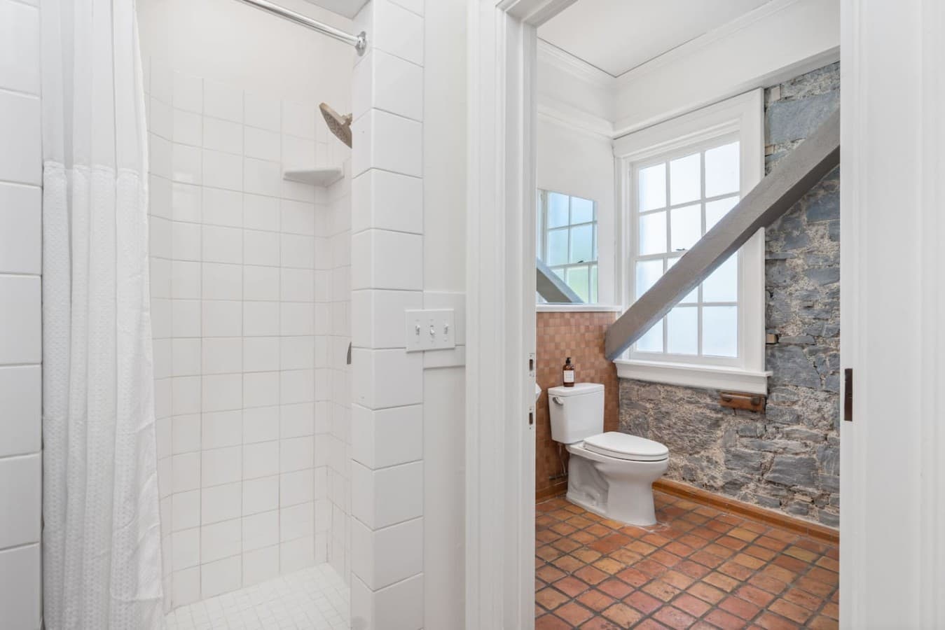 This is the private bathroom inside the room you will be renting offering a bright walk-in shower and classic tile accents.