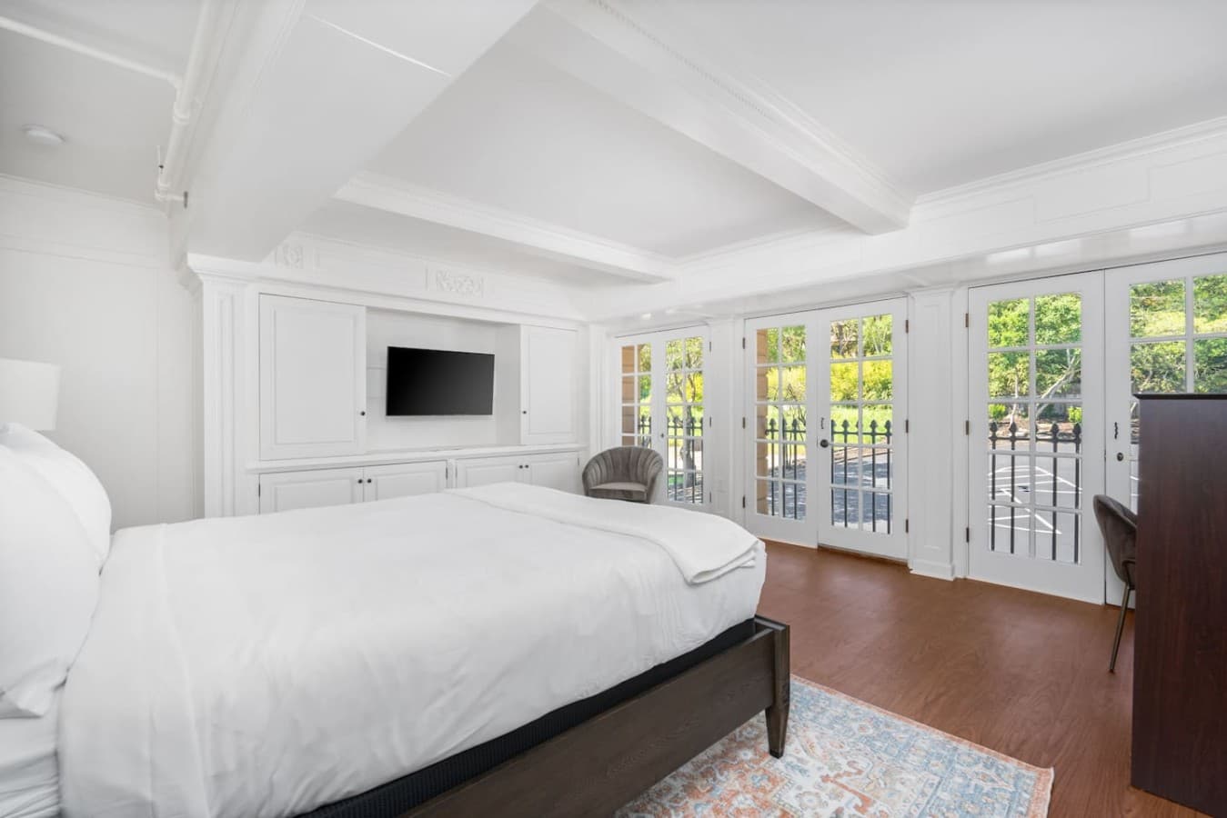 This is the private room you will be renting showcasing a cozy queen bed setup with direct access to the balcony doors.