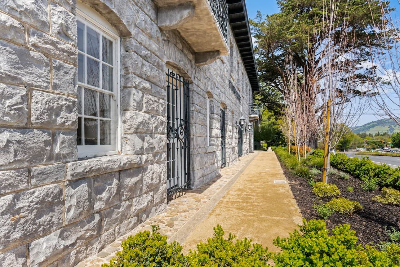 A quiet stone-lined side path offering a peaceful look at the hotel’s unique historic architecture.